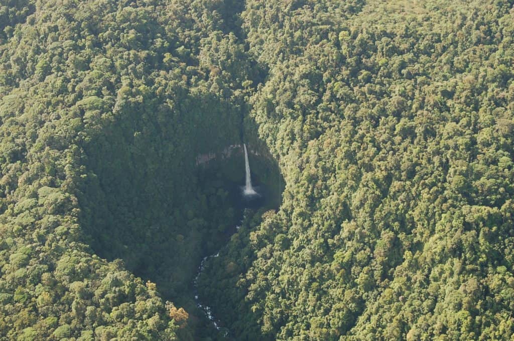 A waterfall surrounded by dense rainforest in Costa Rica