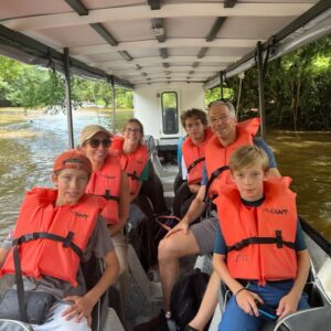 Family exploring Tortuguero canals by boat in Costa Rica