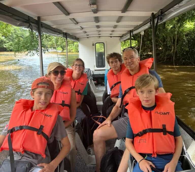 Family exploring Tortuguero canals by boat in Costa Rica