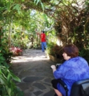 a disabled traveler using a scoot to visit gardens on an accessible adventure in Costa Rica