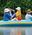 a multigeneration family on a nature safari float on a river in Costa Rica