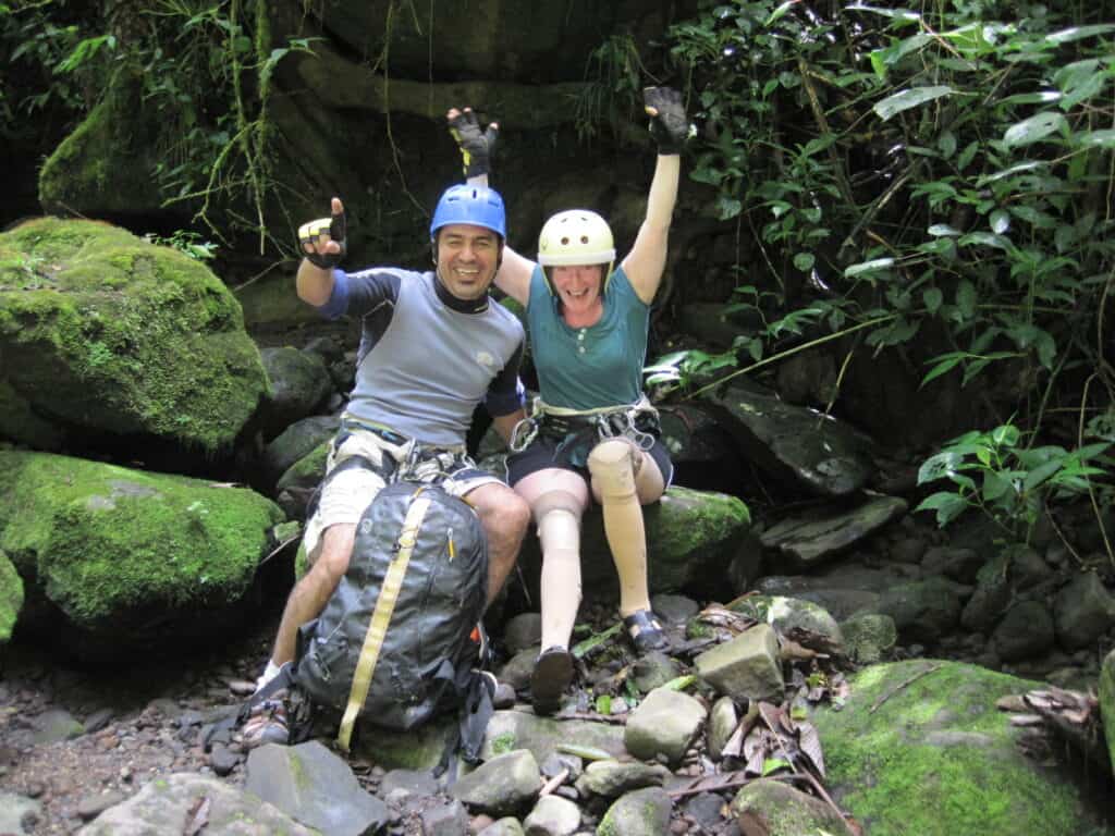 a traveler with leg prosthetics on an accessible canyoning adventure in Costa Rica