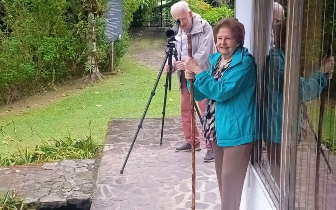 Senior travelers birdwatching in Bosque de Paz