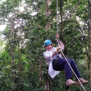 Senior travelers rappelling during a tree climbing adventure in Costa Rica