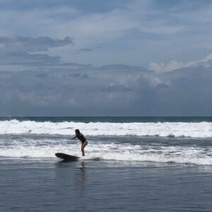 Teenage girl learning to surf in Costa Rica