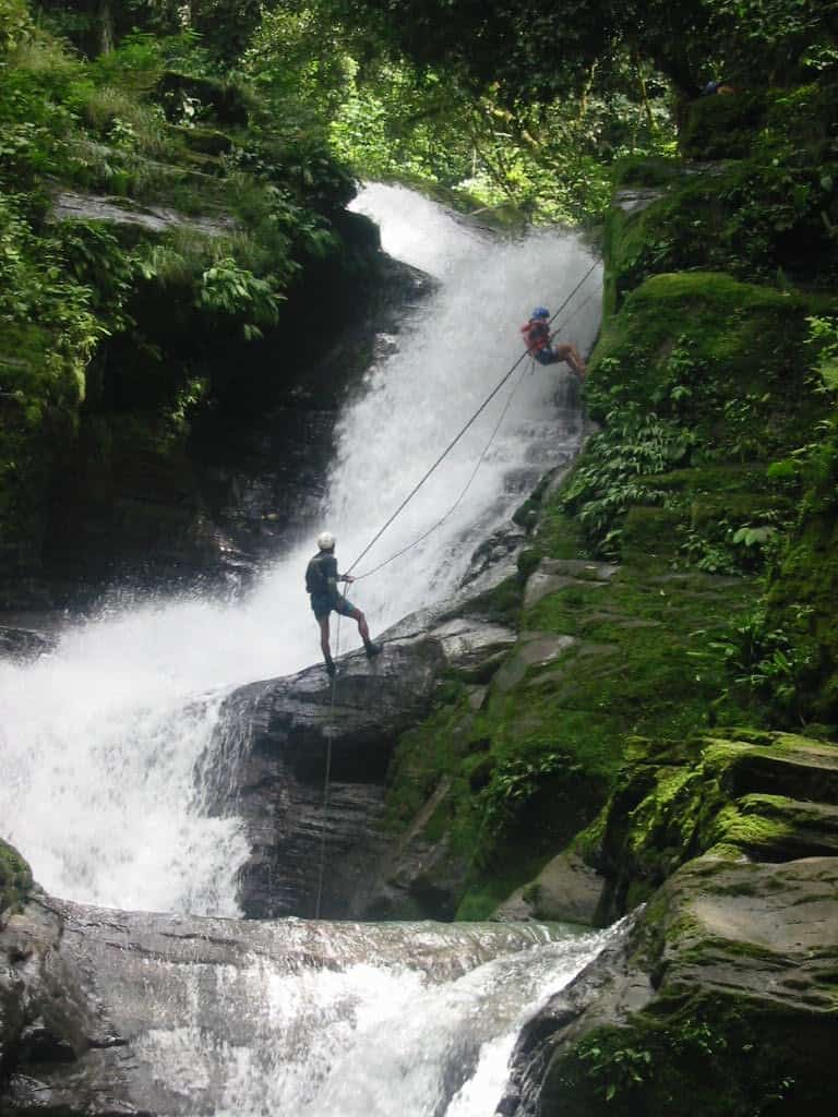 a Serendipity Adventures traveler rappelling down a waterfall in Costa Rica