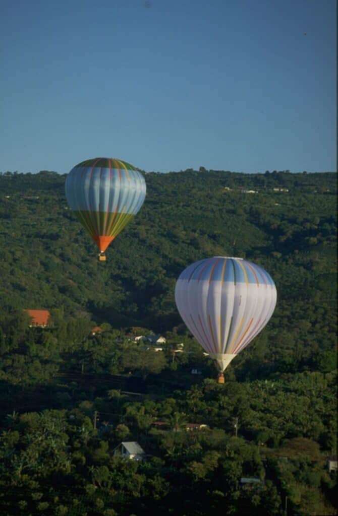 two hot air balloons flying over San Carlos in Costa Rica